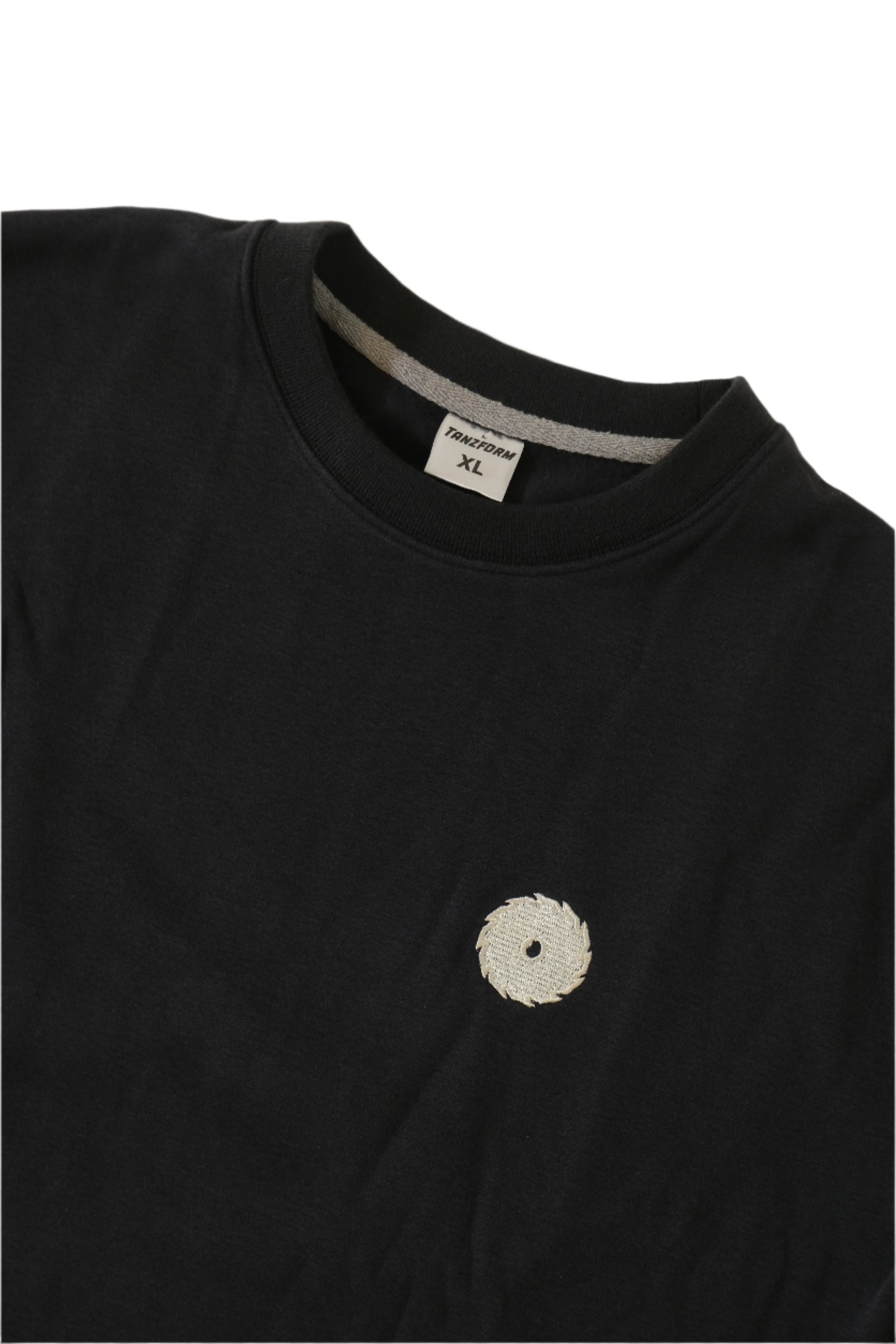 Navy sweater with a small white logo on a light gray background