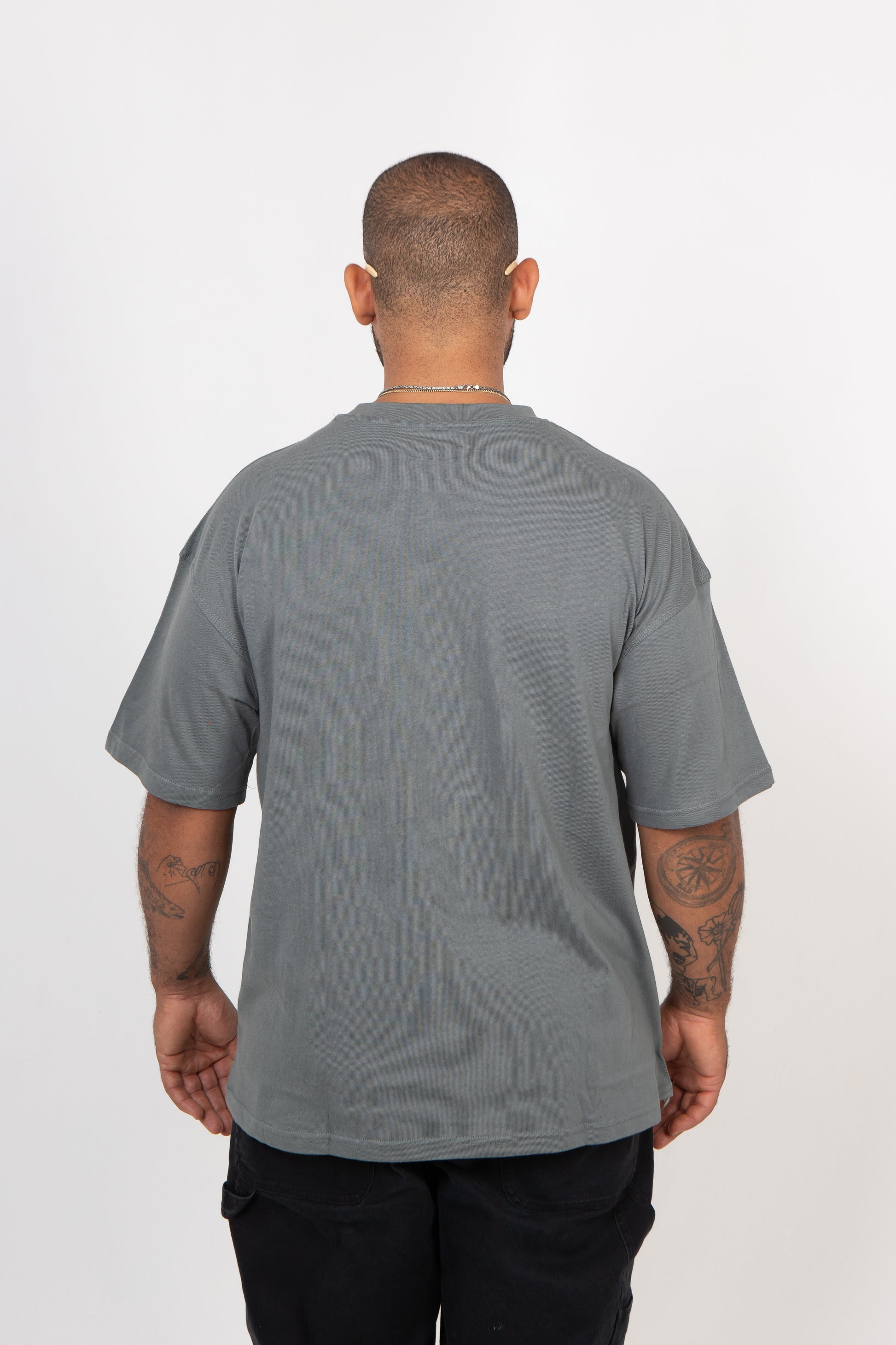 Person wearing a gray t-shirt on a white background