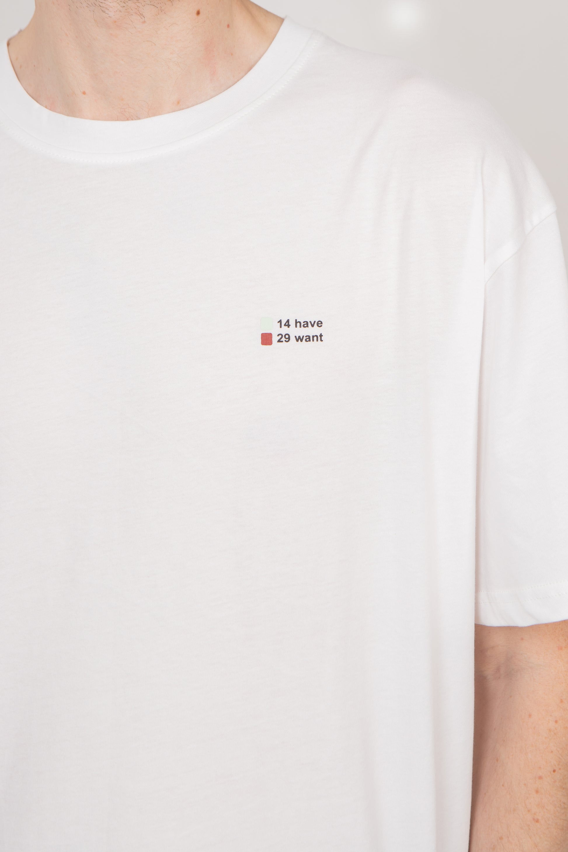White t-shirt with a small text design on a plain background