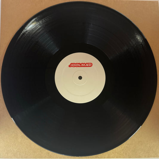 A black vinyl record with 'Joolmad' written in red on the label.