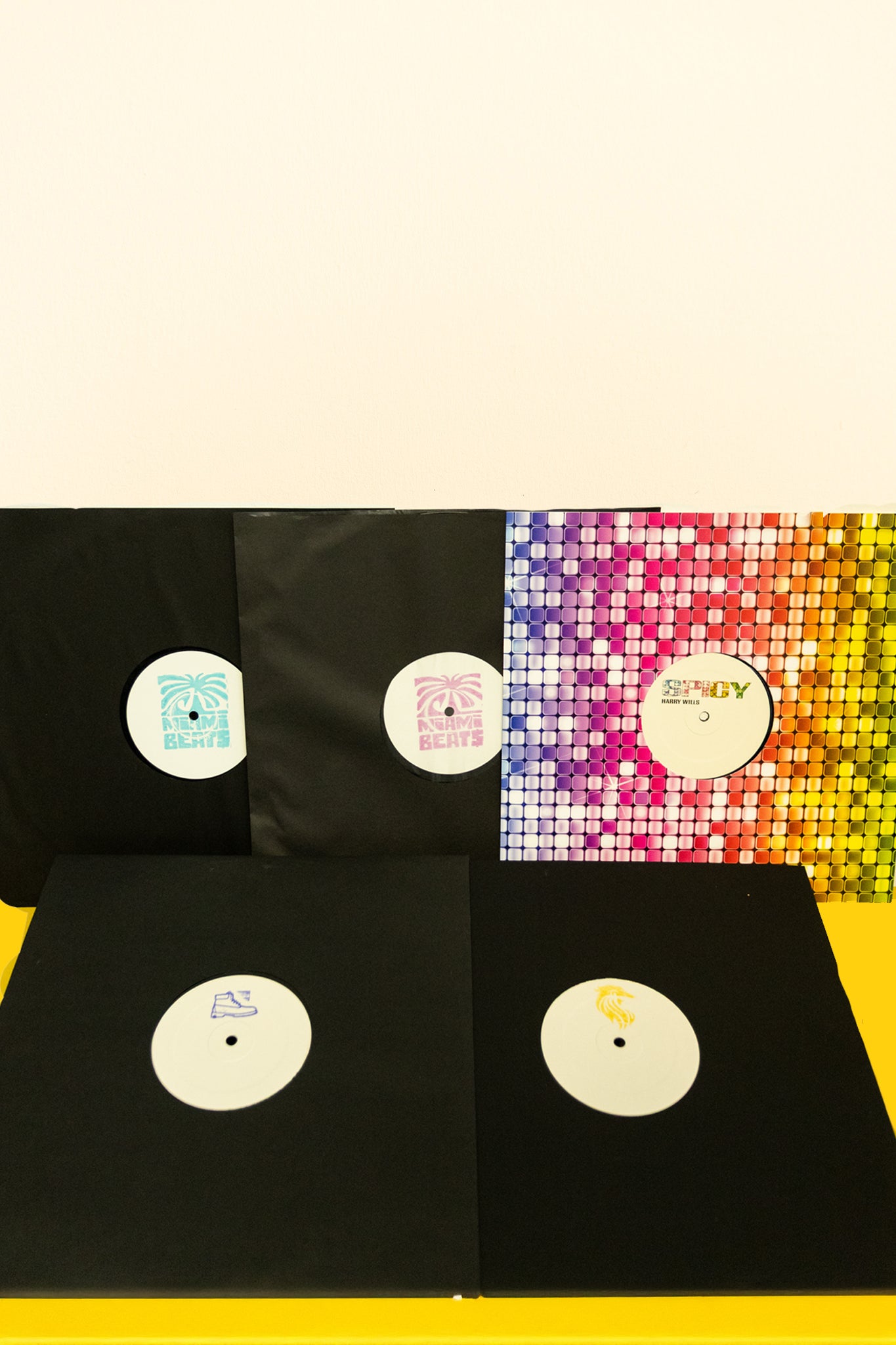 Vinyl records with colorful sleeve designs on a white background