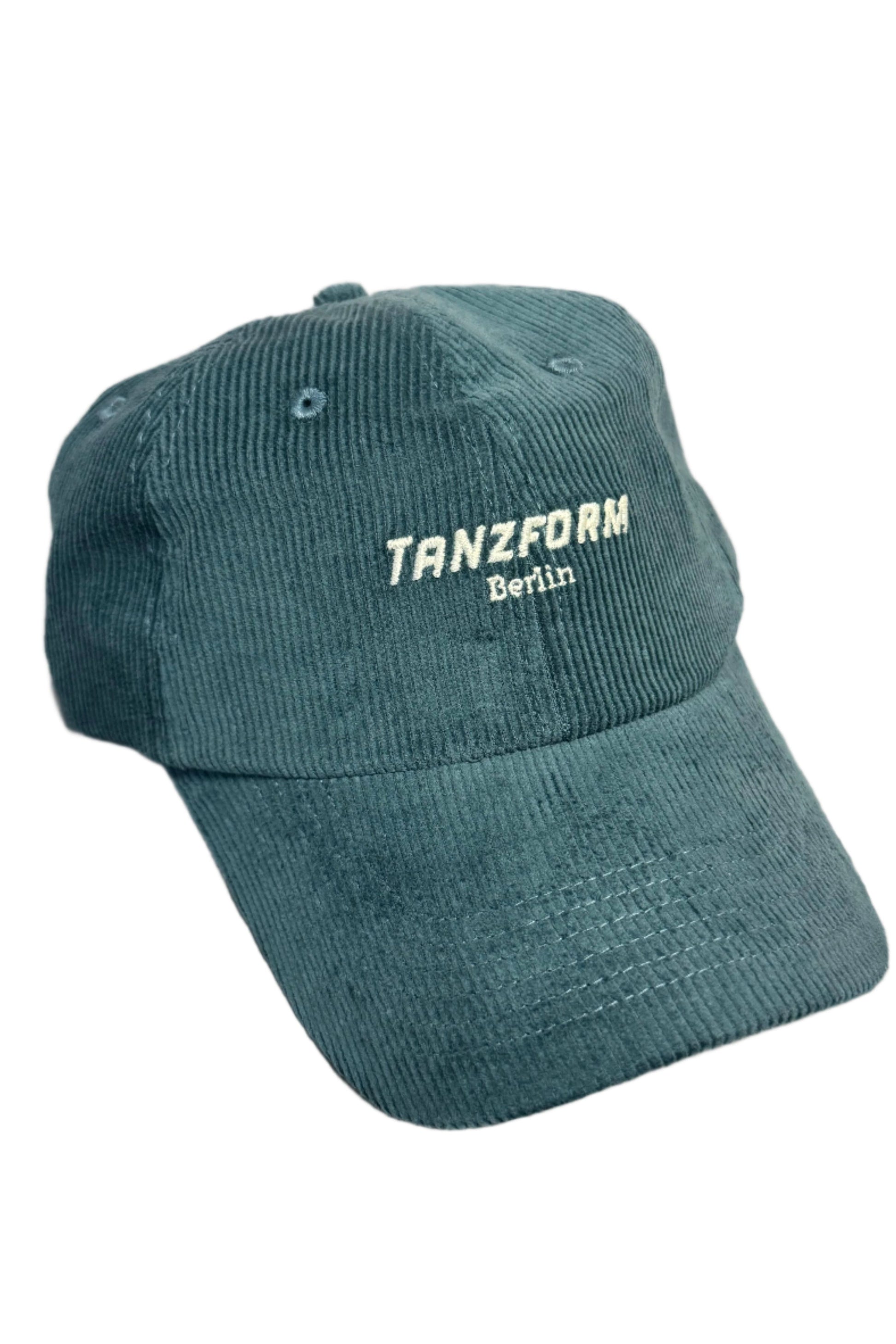 A dark turquoise Tanzform corduroy cap with a curved brim and the brand logo 'Tanzform Berlin' embroidered on the front.
