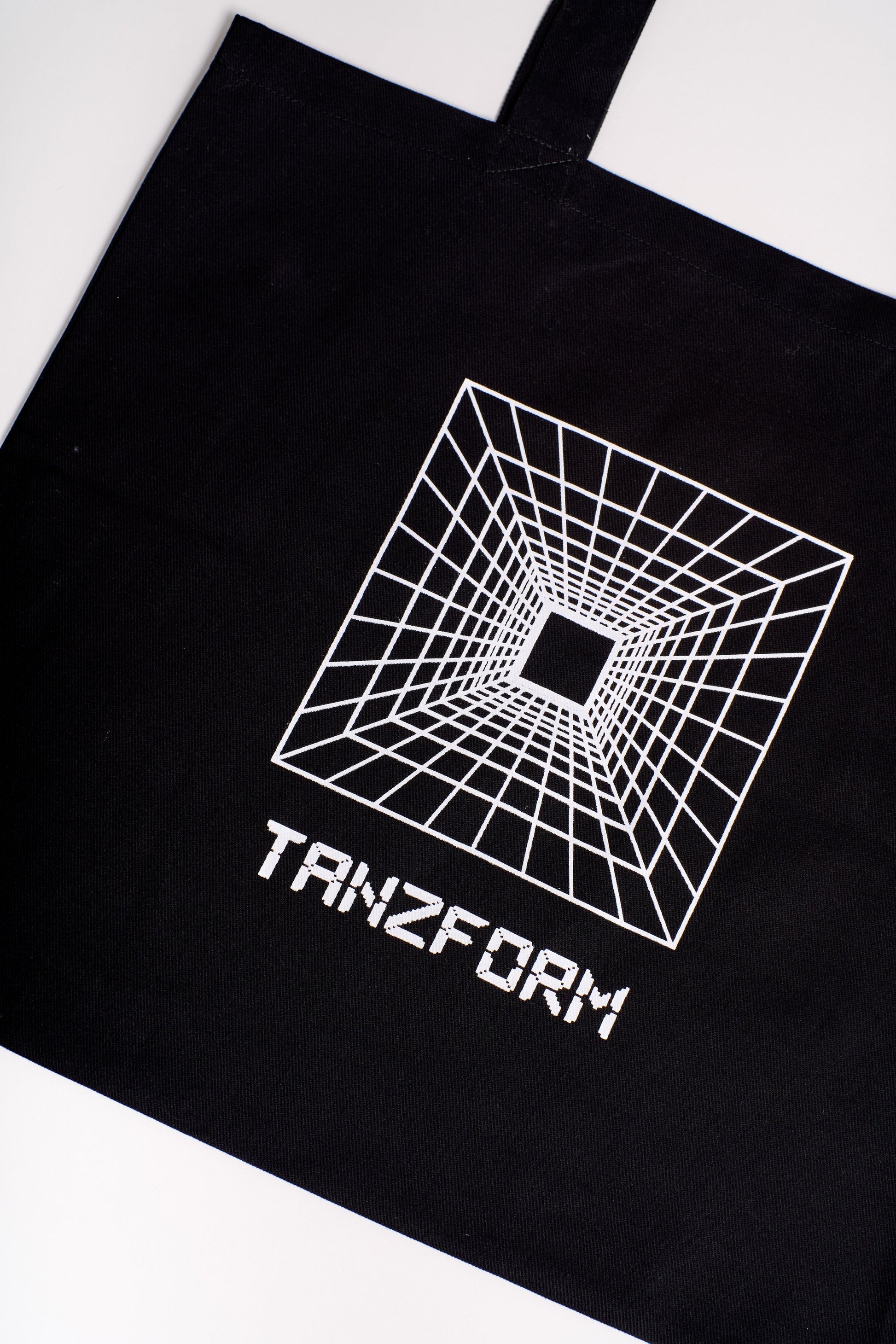 Black cotton tote bag with a white mind portal print on the front.