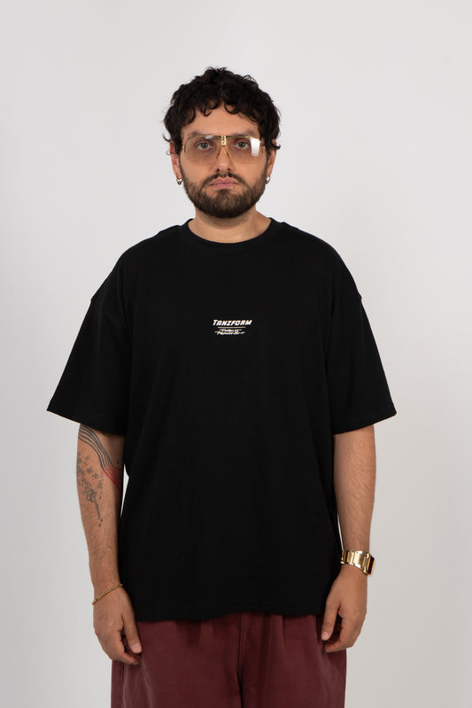 Person wearing a black t-shirt with a logo on a white background