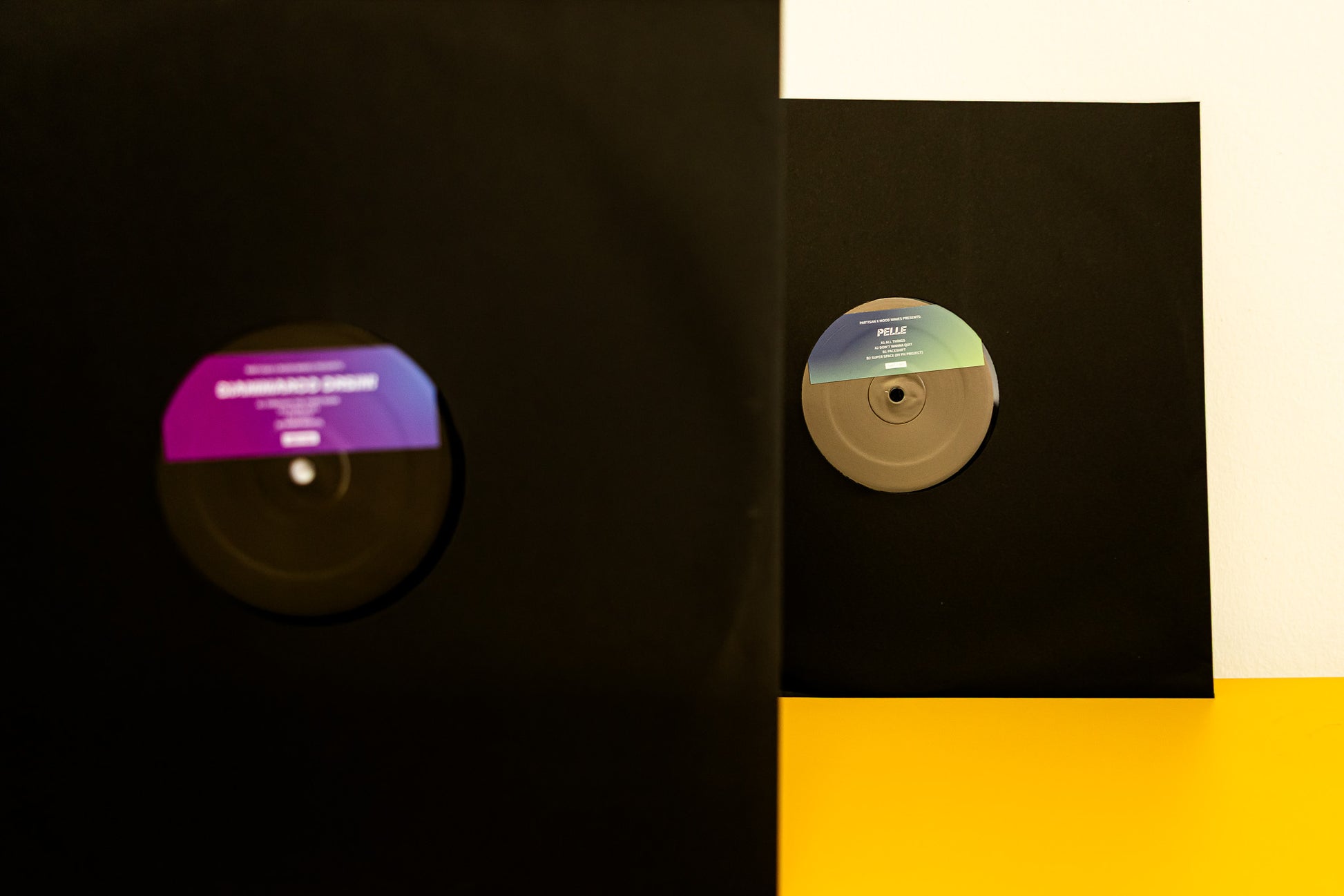 Vinyl records with colorful labels on a black and yellow background