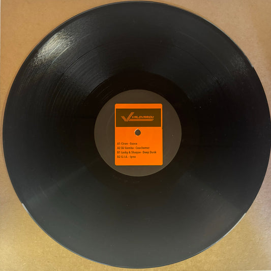 A black vinyl record with a label in the center that includes orange and black text.