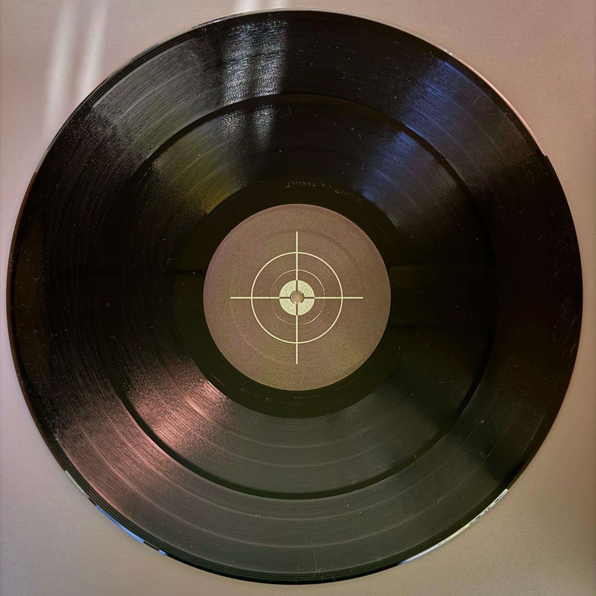 vinyl record with electronic music and artwork has a target with grey background