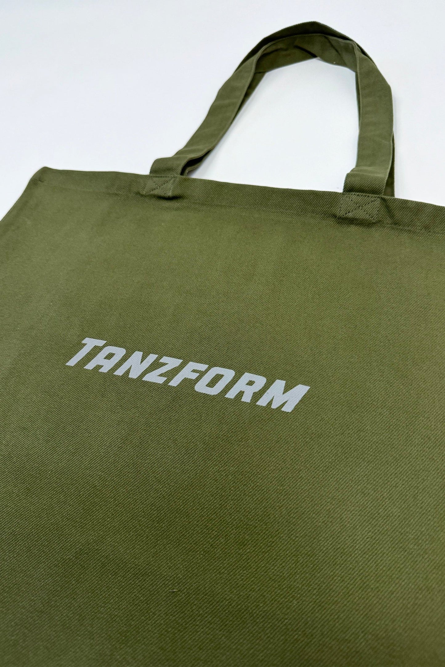Green Tanzform Tote Bag with a logo close up