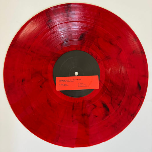 red vinyl record with a black center label and a red sticker on it with track names