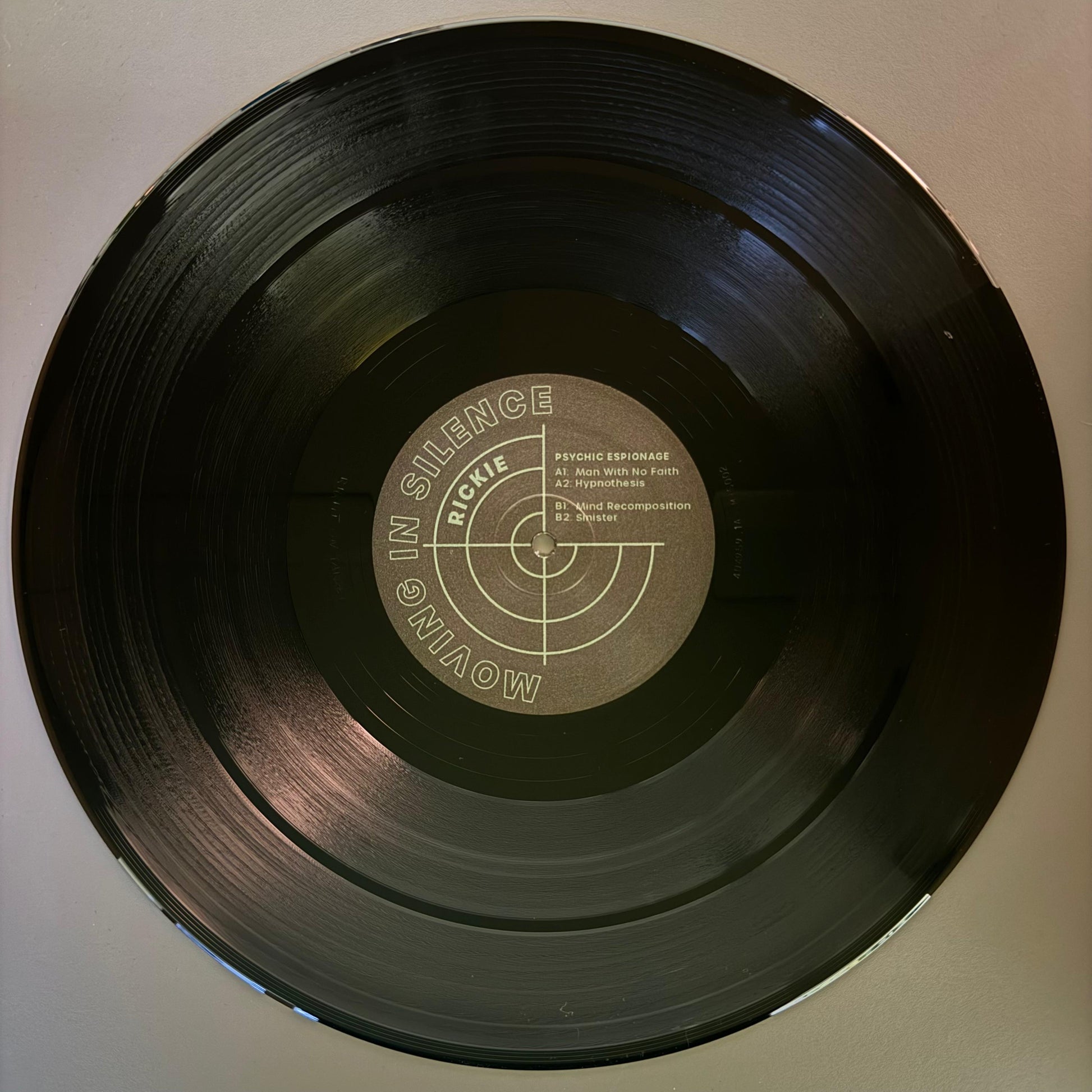 A black techno vinyl record with a label in the center that looks like a target