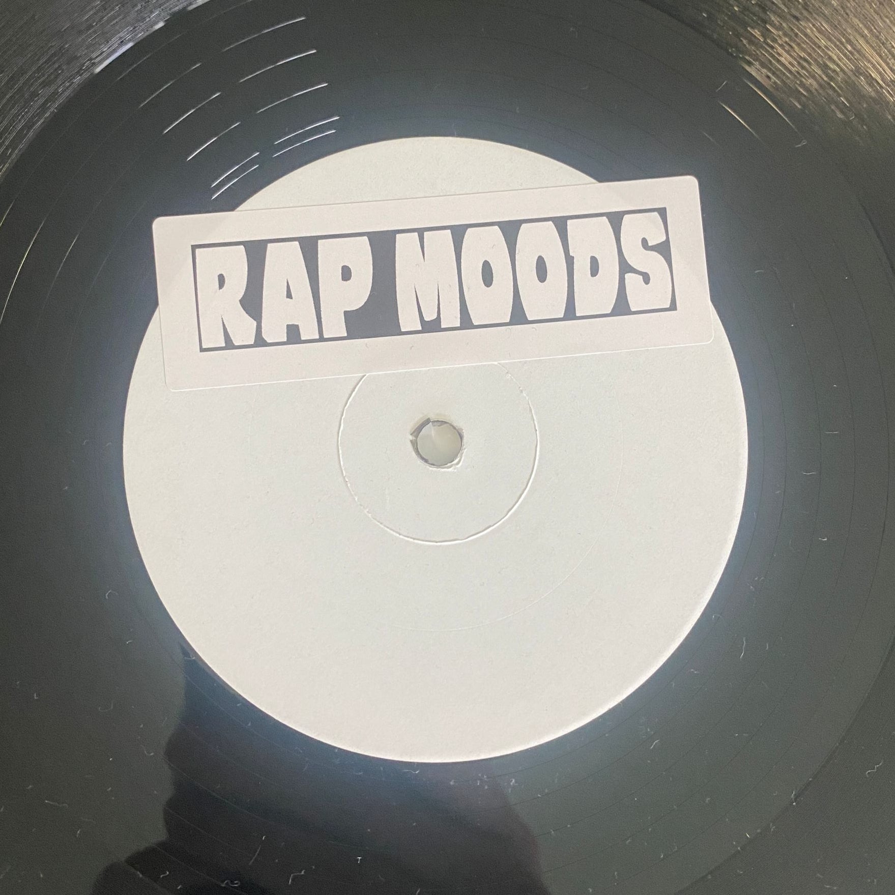 Vinyl record with a 'Rap Moods' label on a dark background