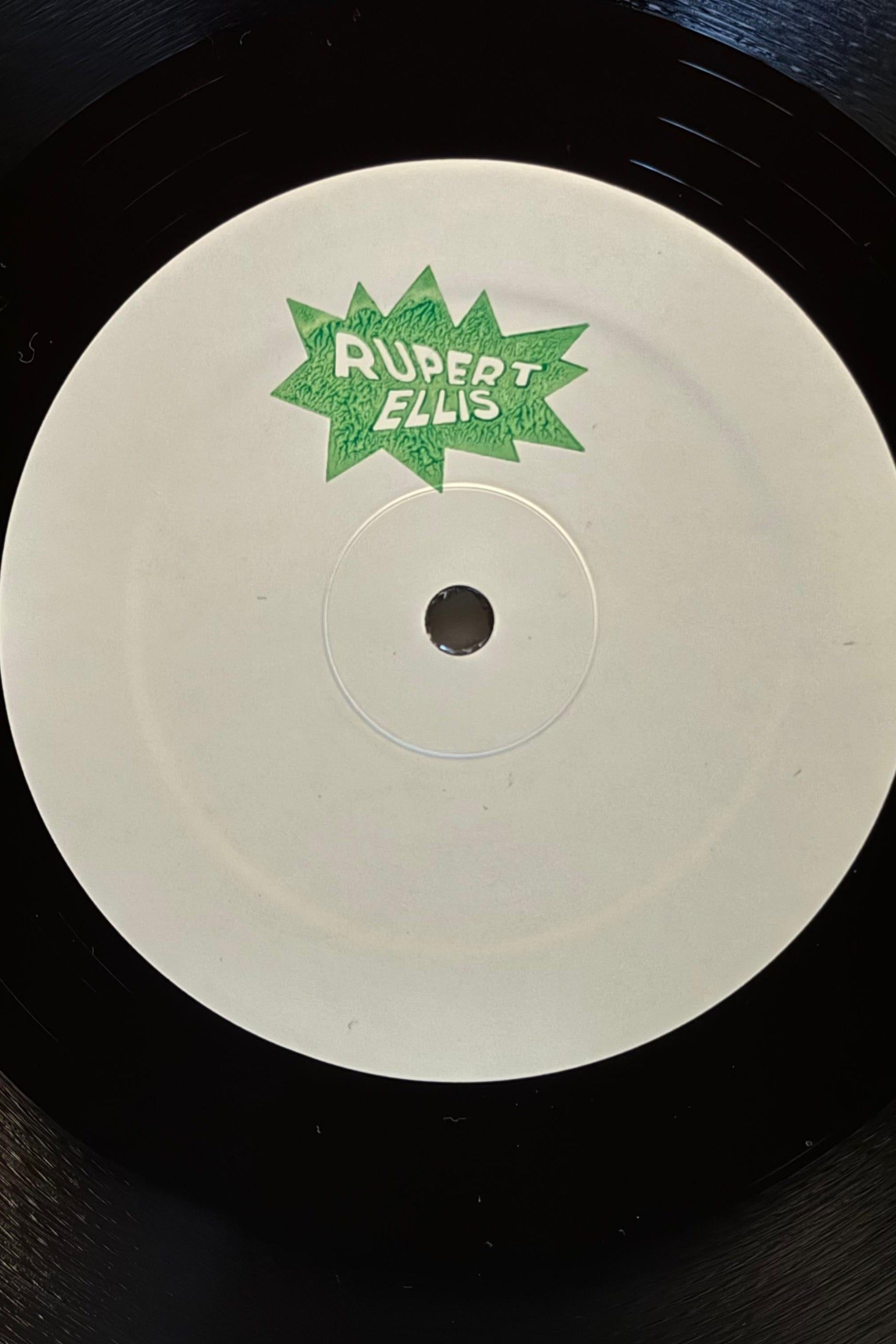 White label vinyl record with a green stamp saying ruppert ellis