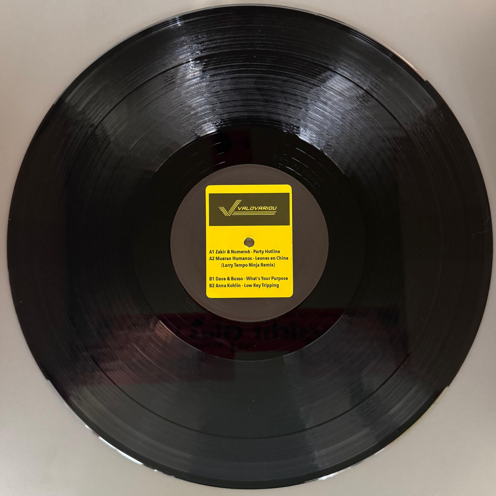 Black vinyl record with yellow artwork and tech-house music on it