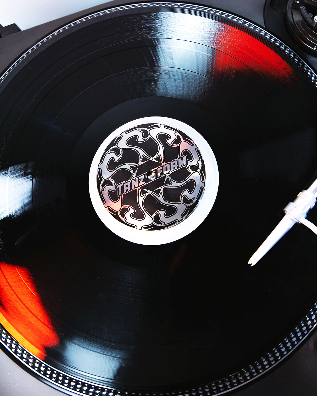 Close-up of a vinyl record with a brand logo on a turntable