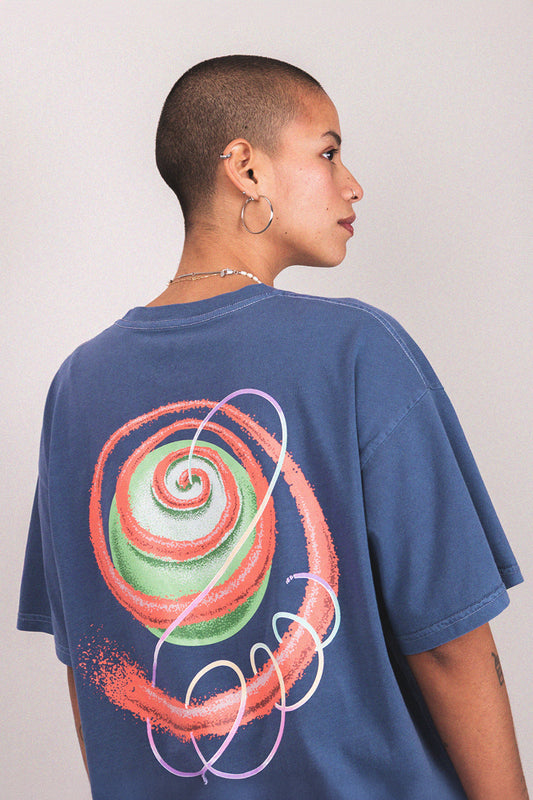 Person wearing a blue trippy t-shirt with a colorful spiral design on the back 