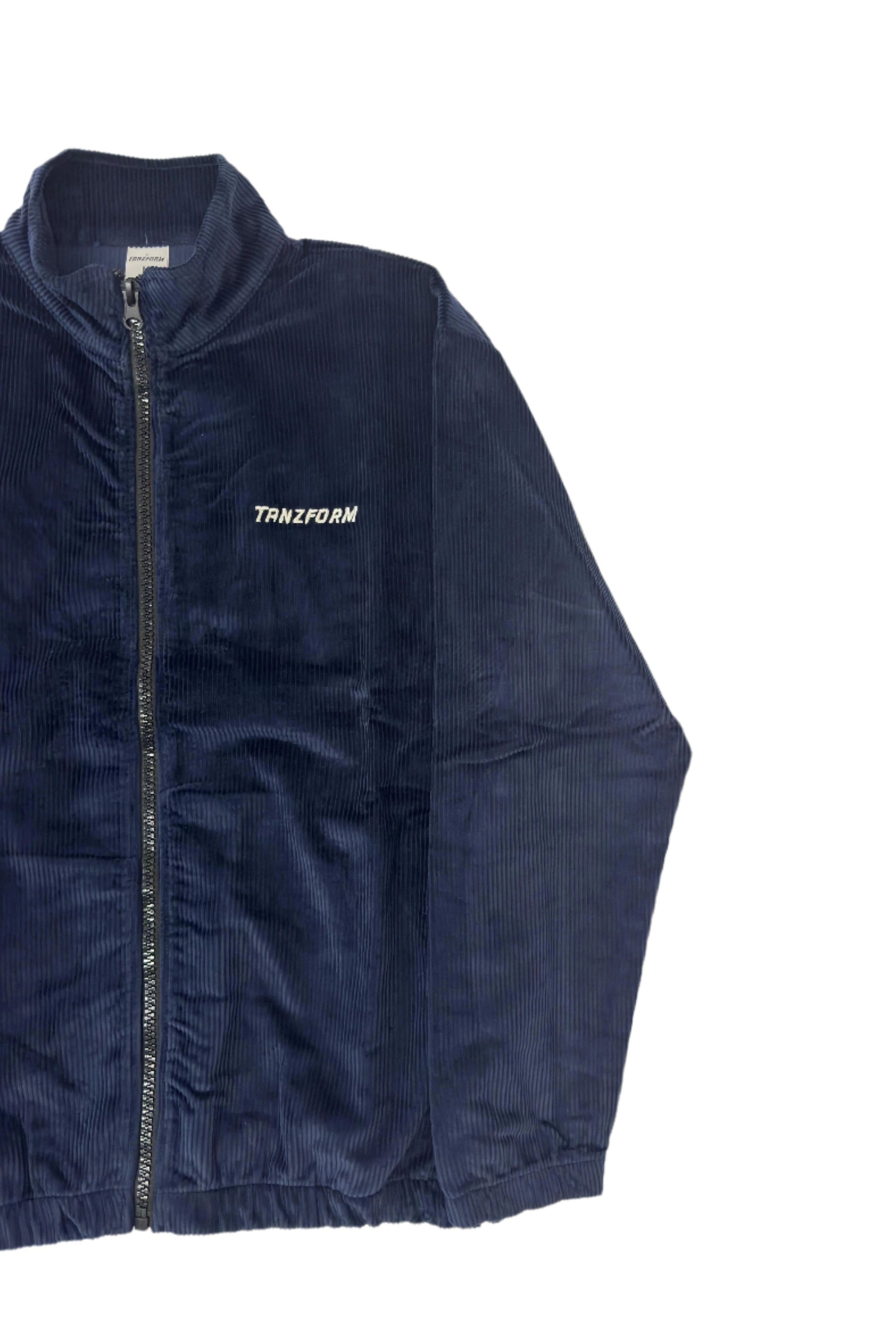 A blue corduroy jacket with a zipper front and the brand name 'Tanzform' visible on the collar.