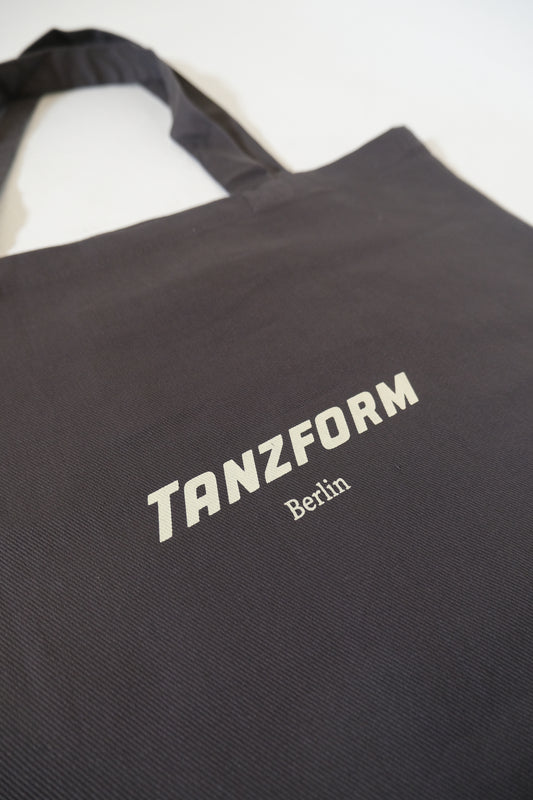 Grey bag with 'TANZFORM Berlin' text on a white background