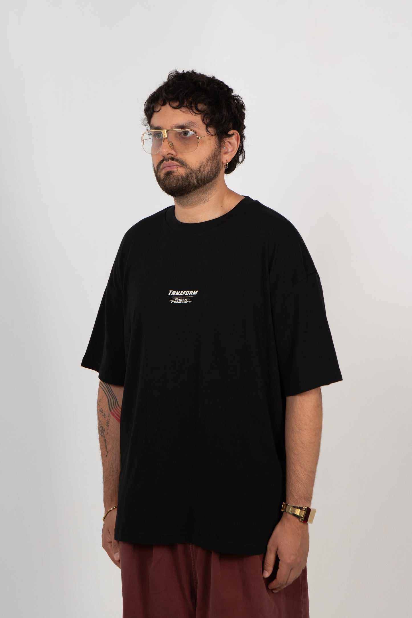 Person wearing a black t-shirt with a logo on a white background