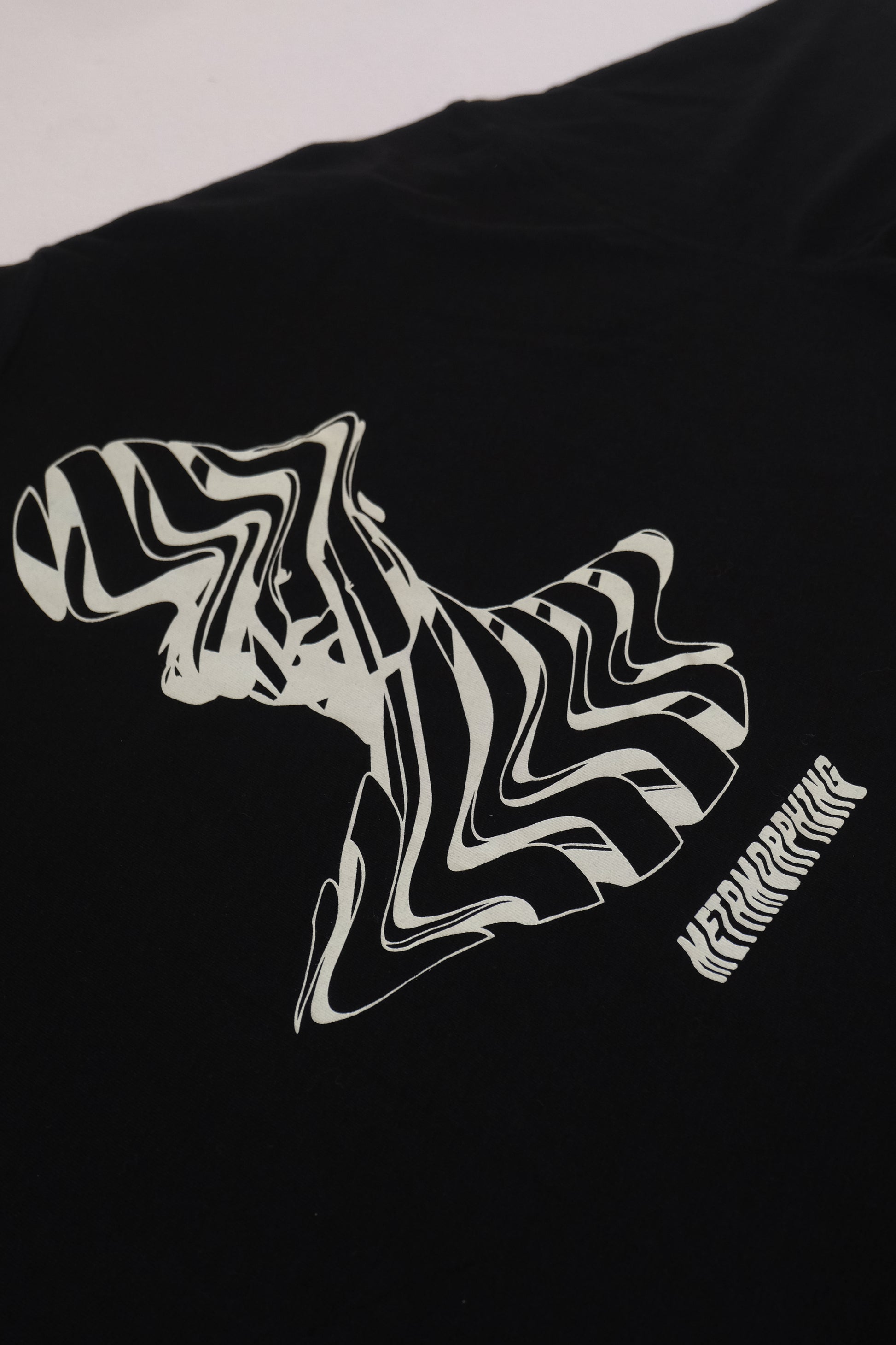 Black t-shirt with white abstract design and text on a plain background