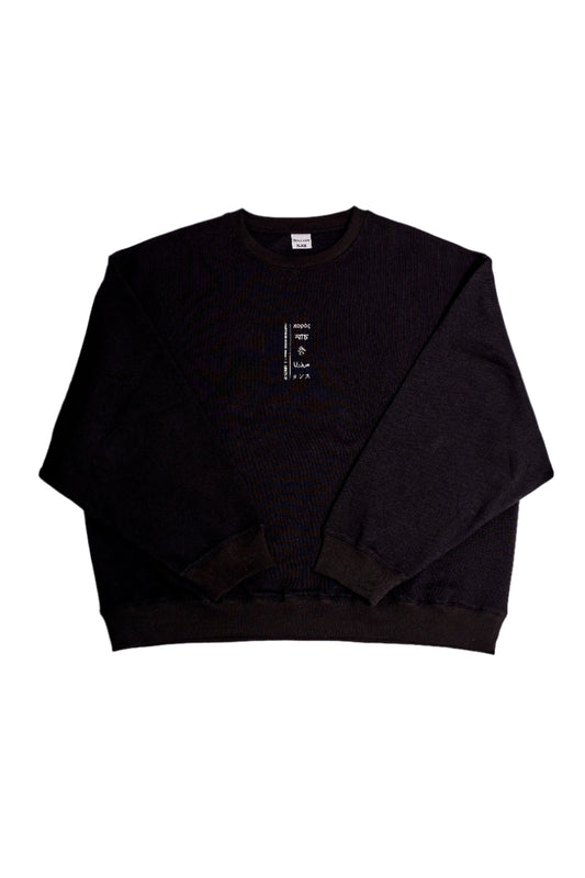 A black cotton sweater with extra wide sleeves, displayed on a white background.