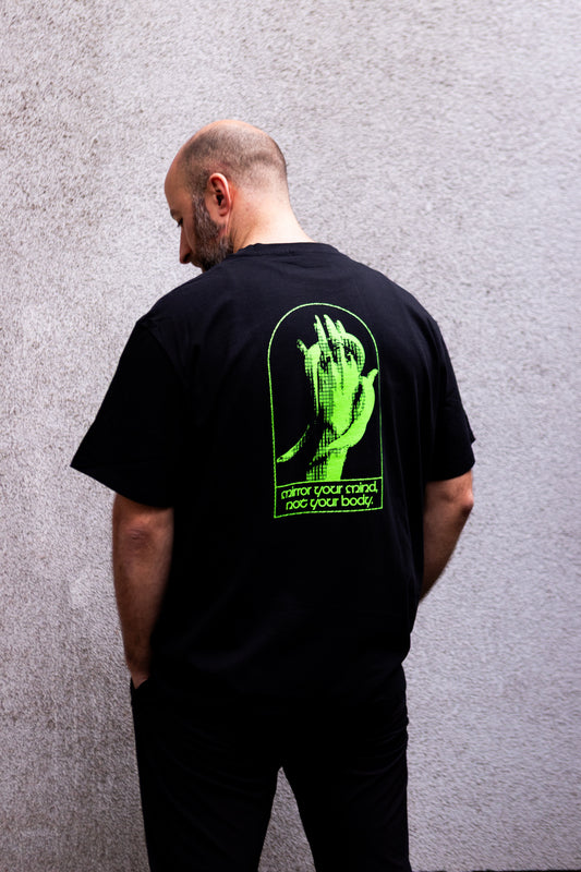 man wearing an oversized black 180GSM berlin club culture tshirt 