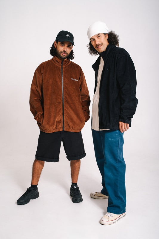 two models wearing corduroy jackets in brown and black